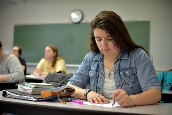 Student taking notes in class